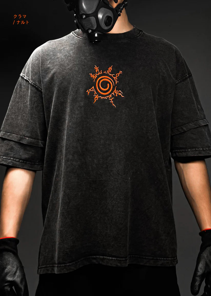 Person wearing a black t-shirt with an orange and white symbol and a gas mask on a dark background