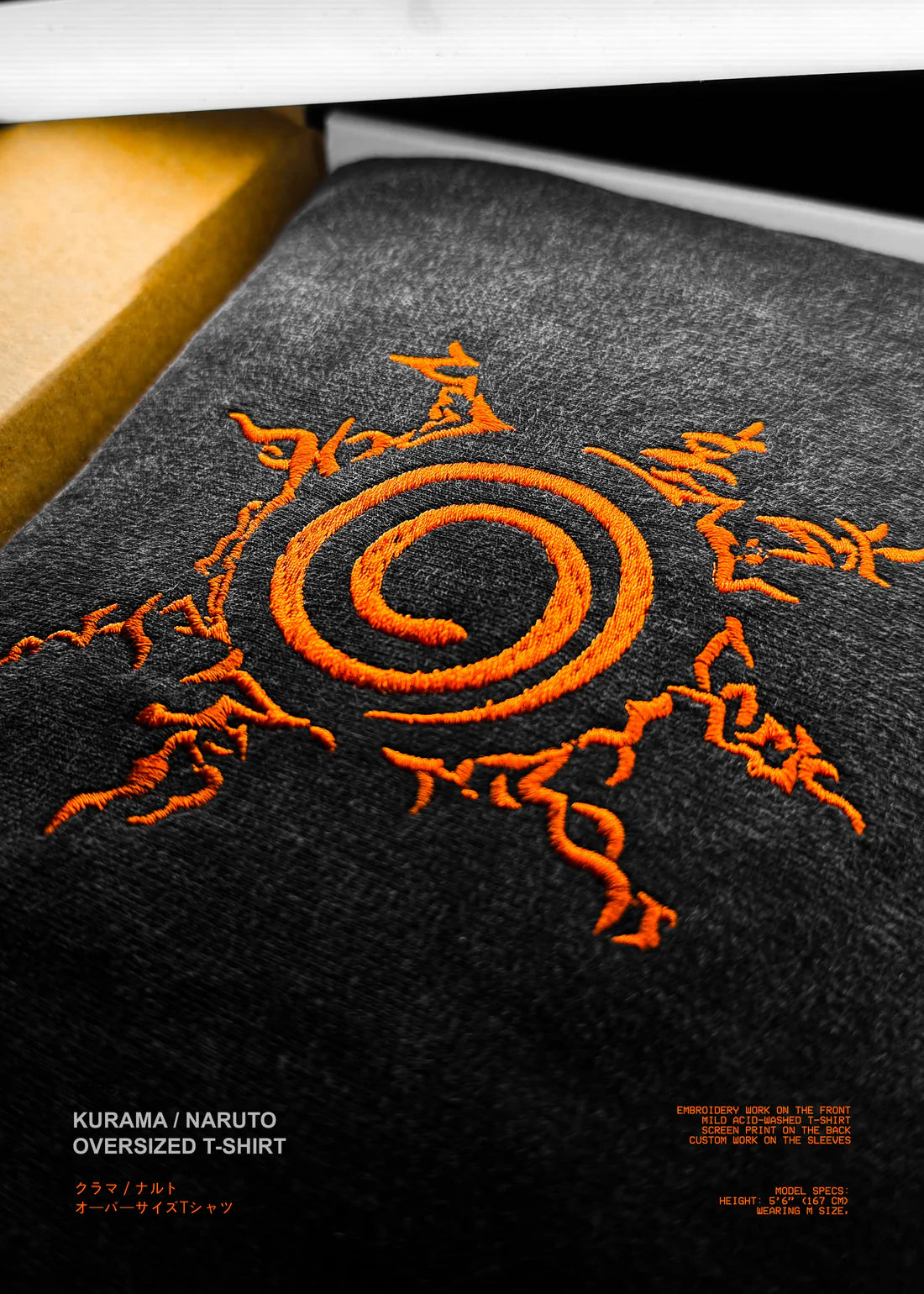 Black t-shirt with orange spiral design on a black background